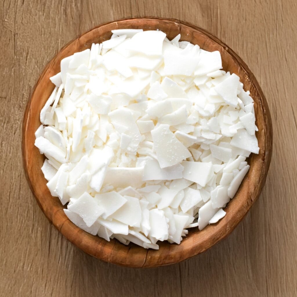 Soy wax flakes in a wooden bowl